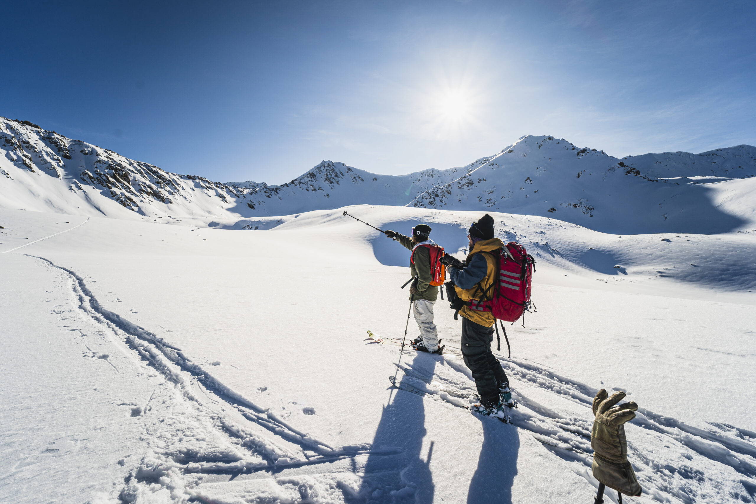 Skiers skinning uphill in the backcountry